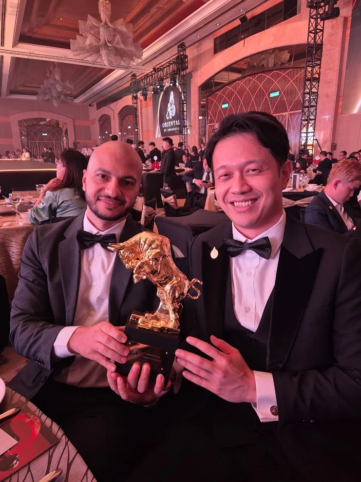 Catalyst AI leaders holding a Golden Bull trophy at the award ceremony